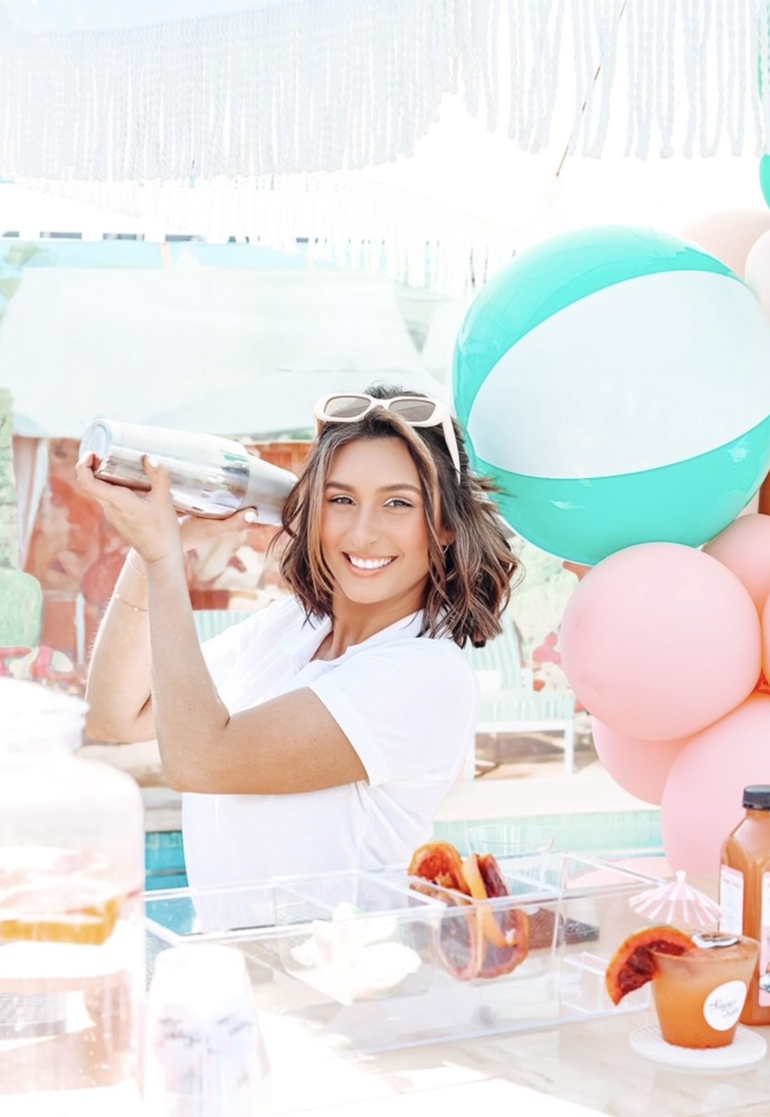 Marisa Zaremba mixing a cocktail behind a colorful Sugar On The Rim bar