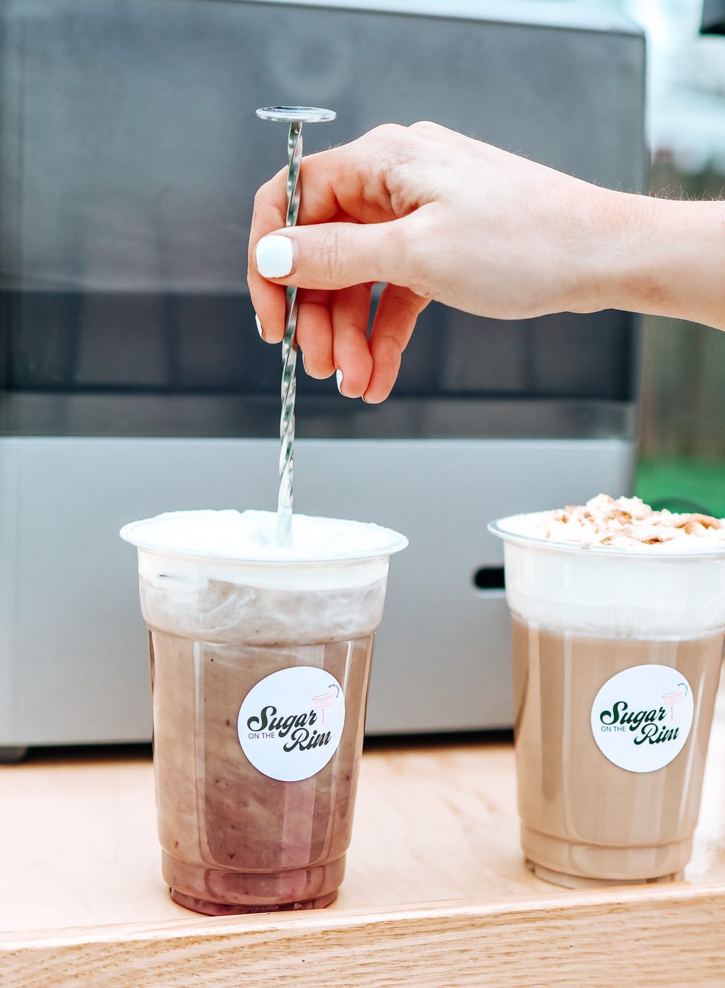 Iced lattes being finished at the Sugar On The Rim espresso bar