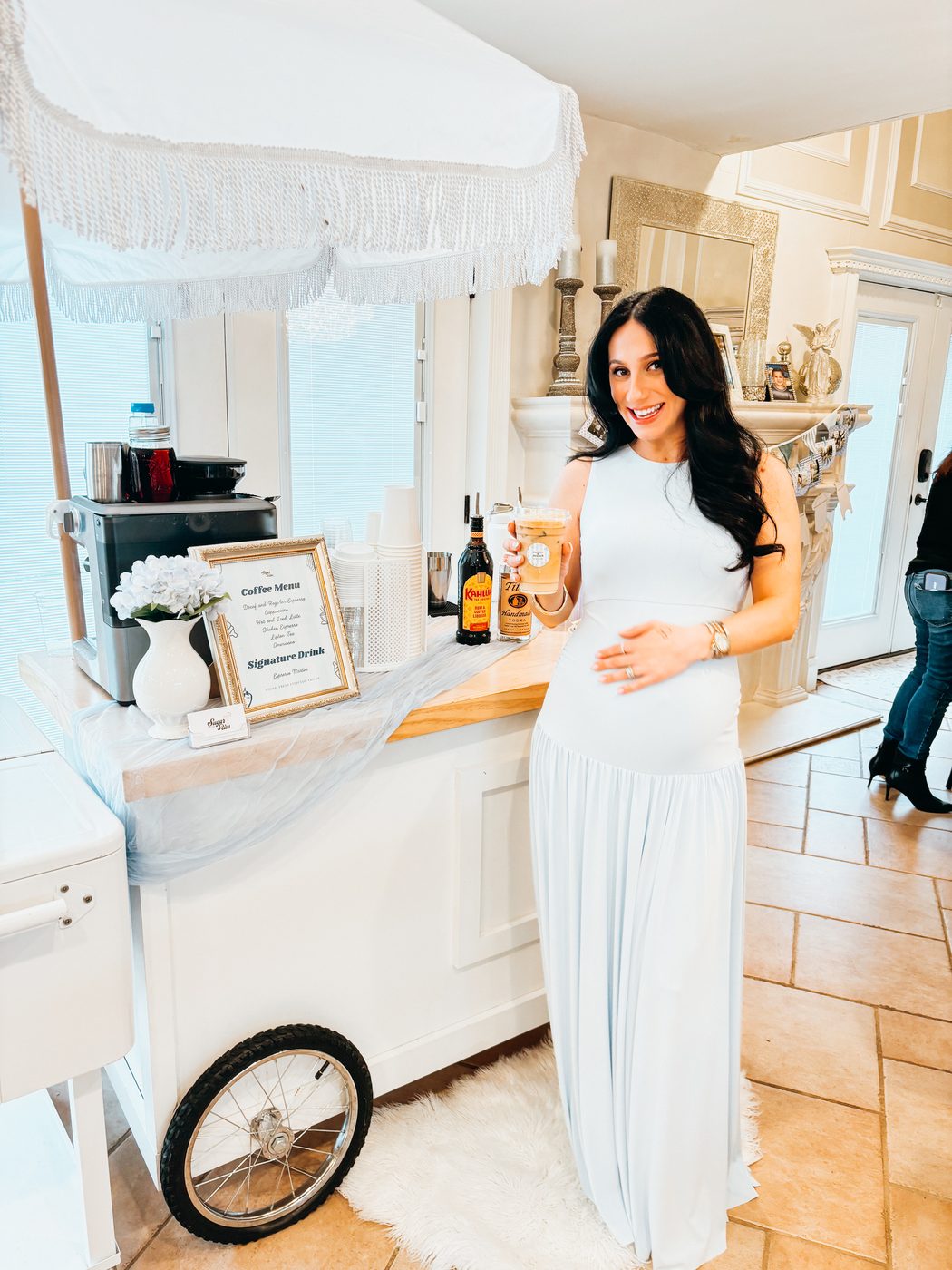 Marisa beside a styled Sugar On The Rim drink cart holding an iced latte